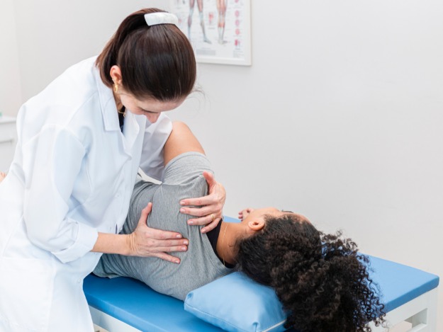 doctor examining patient with unstable shoulder