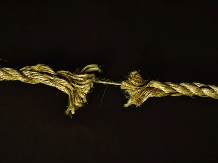 rope partially torn frayed leaving one strand intact