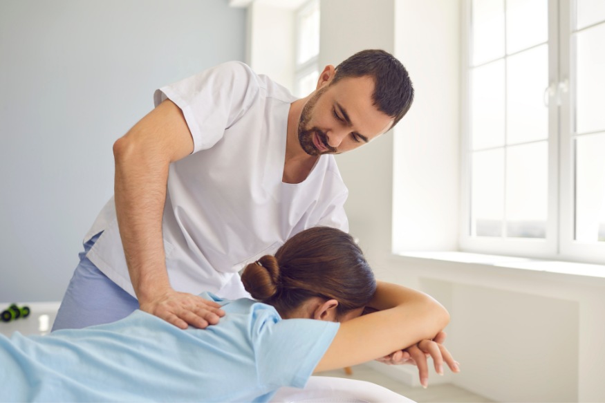 physical therapist giving shoulder rehab