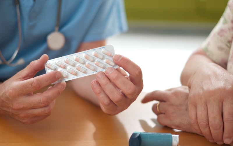 doctor holding package of medication