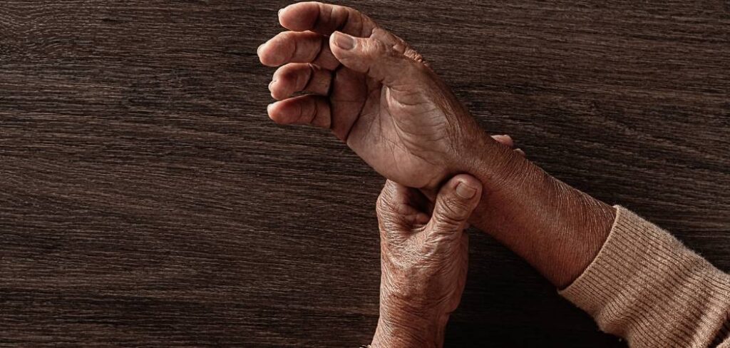 elderly woman holding her wrist