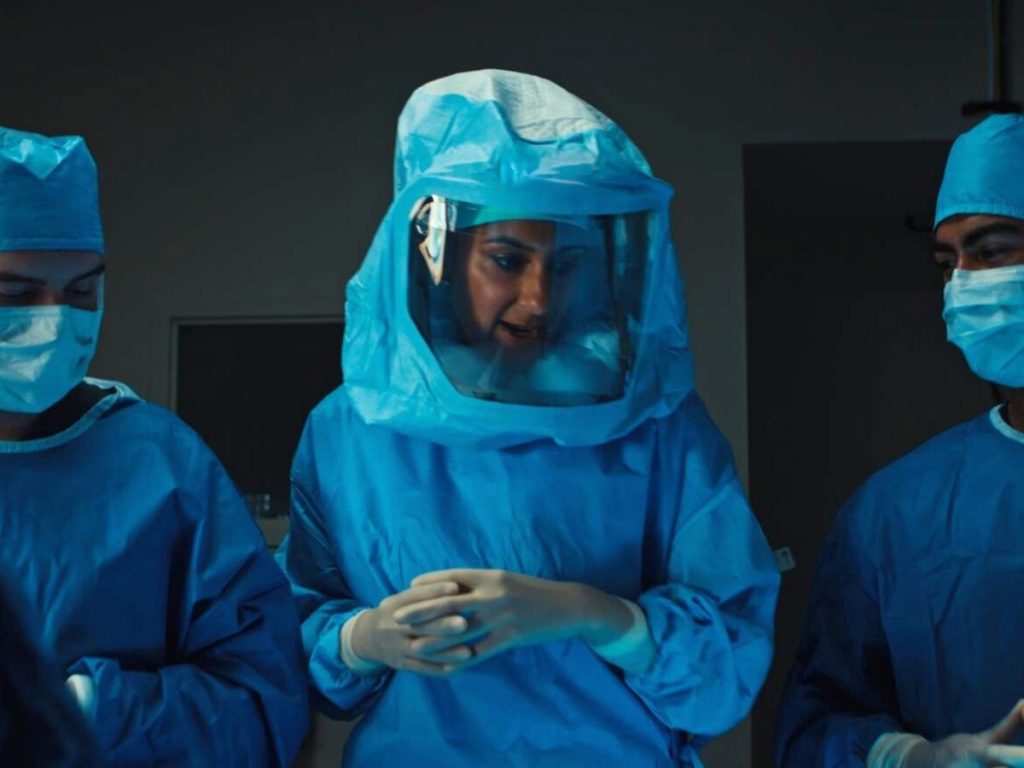 Surgeon in knee replacement case - scrubbed in with surgical hood