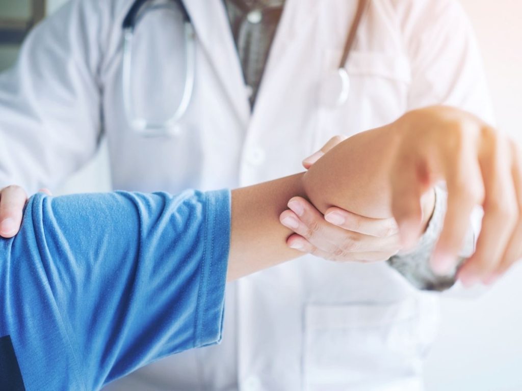 [Image of a physical therapist guiding a patient through a shoulder exercise