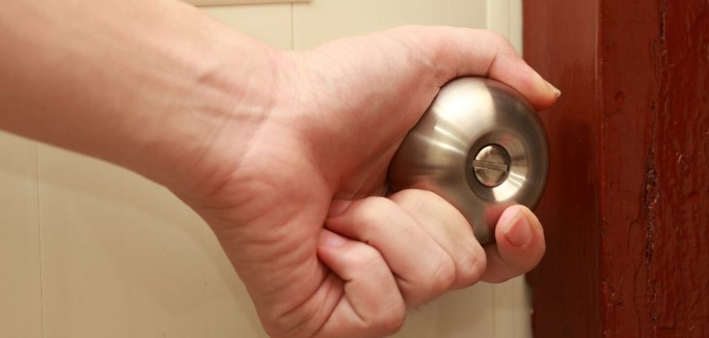 Image of a person opening a doorknob