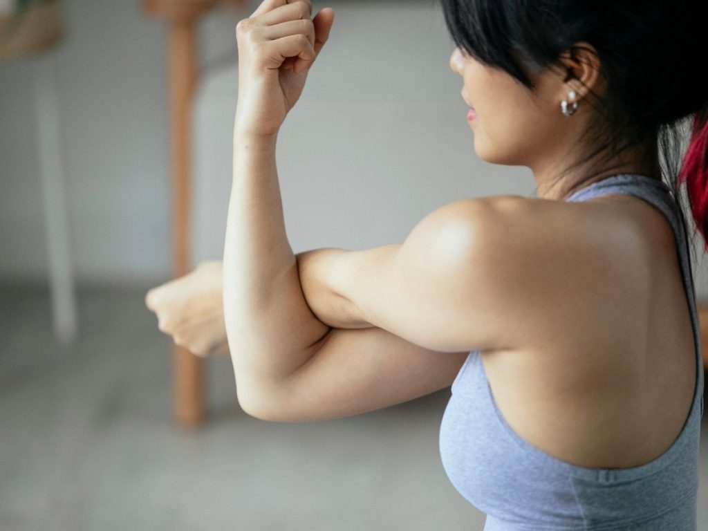 woman stretching arms for recovery