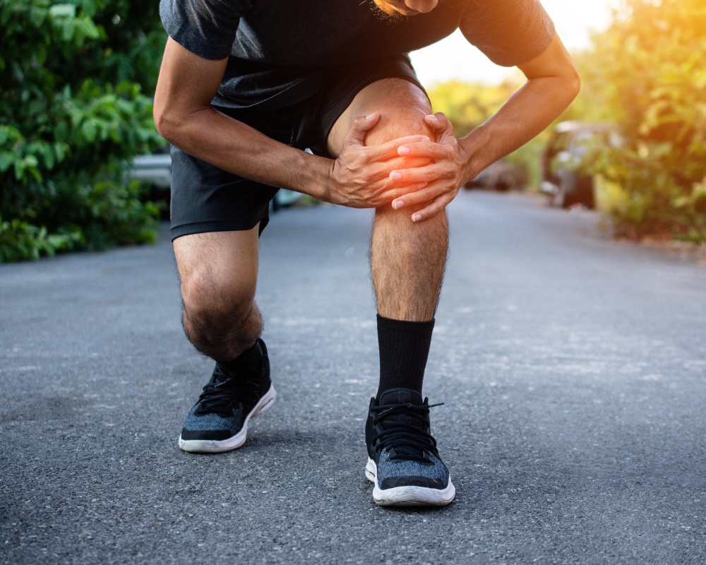 Athlete clutching injured knee