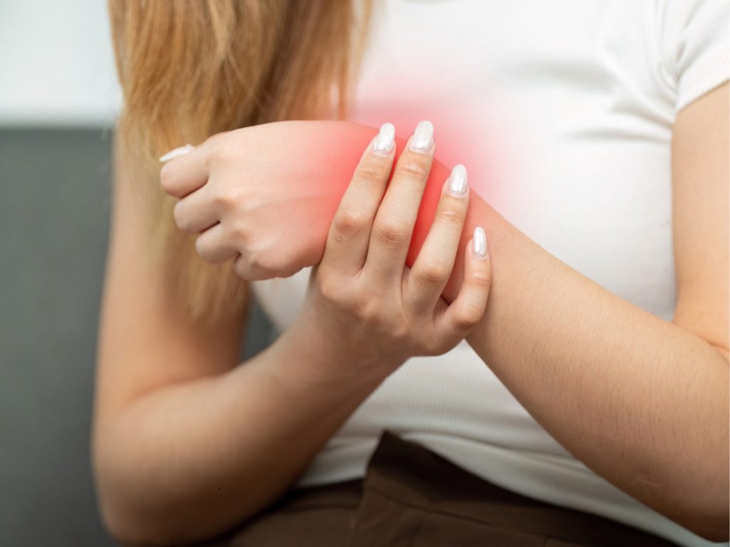 Woman holds painful wrist