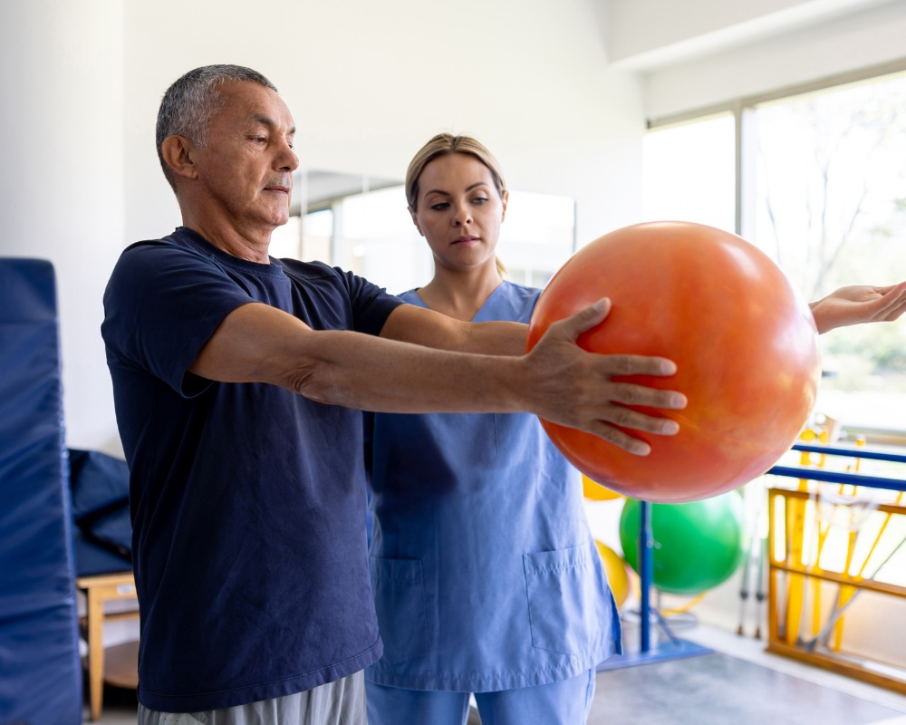 Physical therapist working with patient through rehabilitation