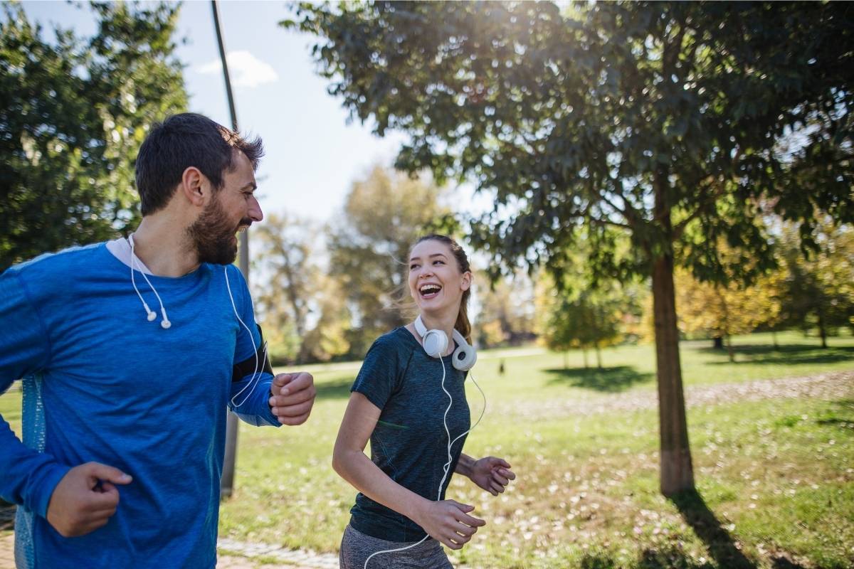 A woman and a man having a laugh whilst on a run or jog