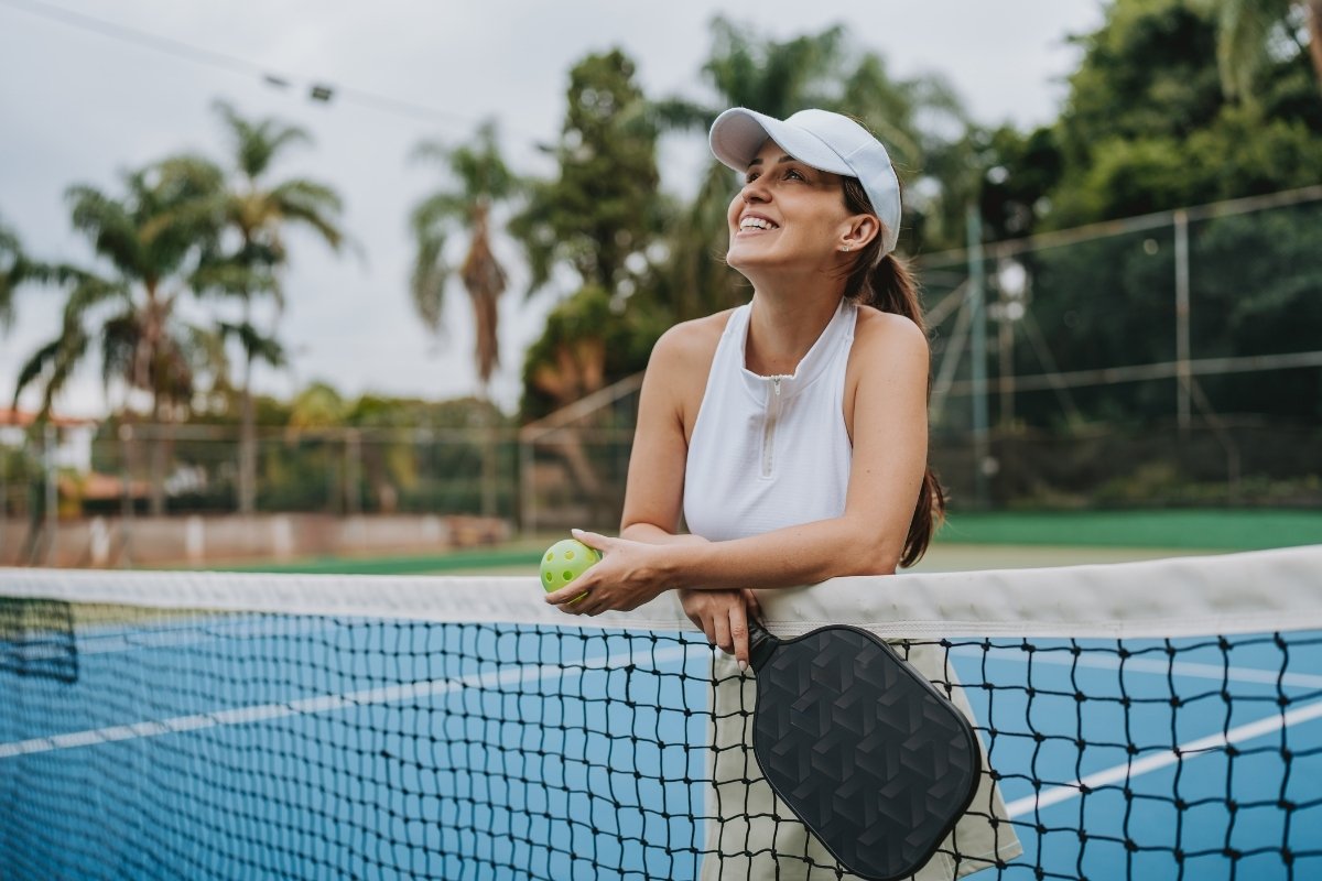 A woman smiles and looks into the distance during a game of squash (1)