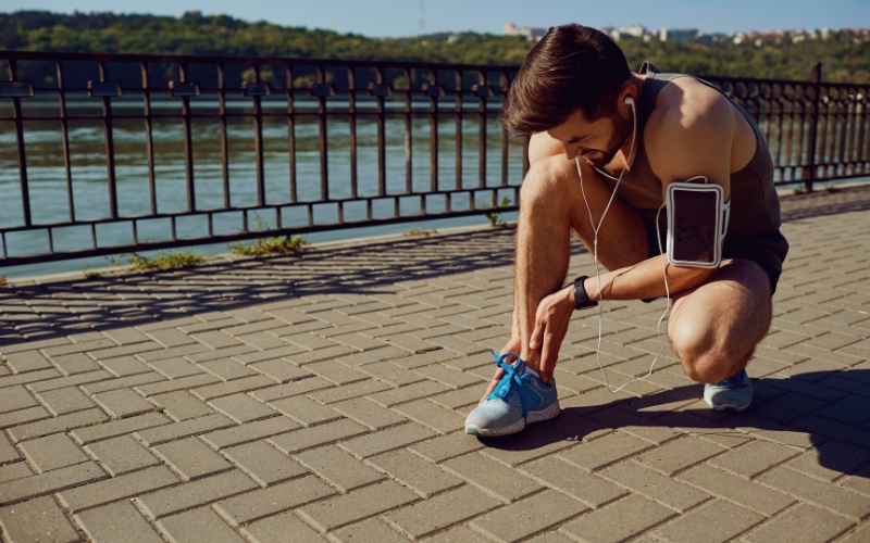 Athlete holding injured foot after exercising
