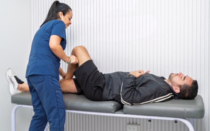 Female physiotherapist with male client