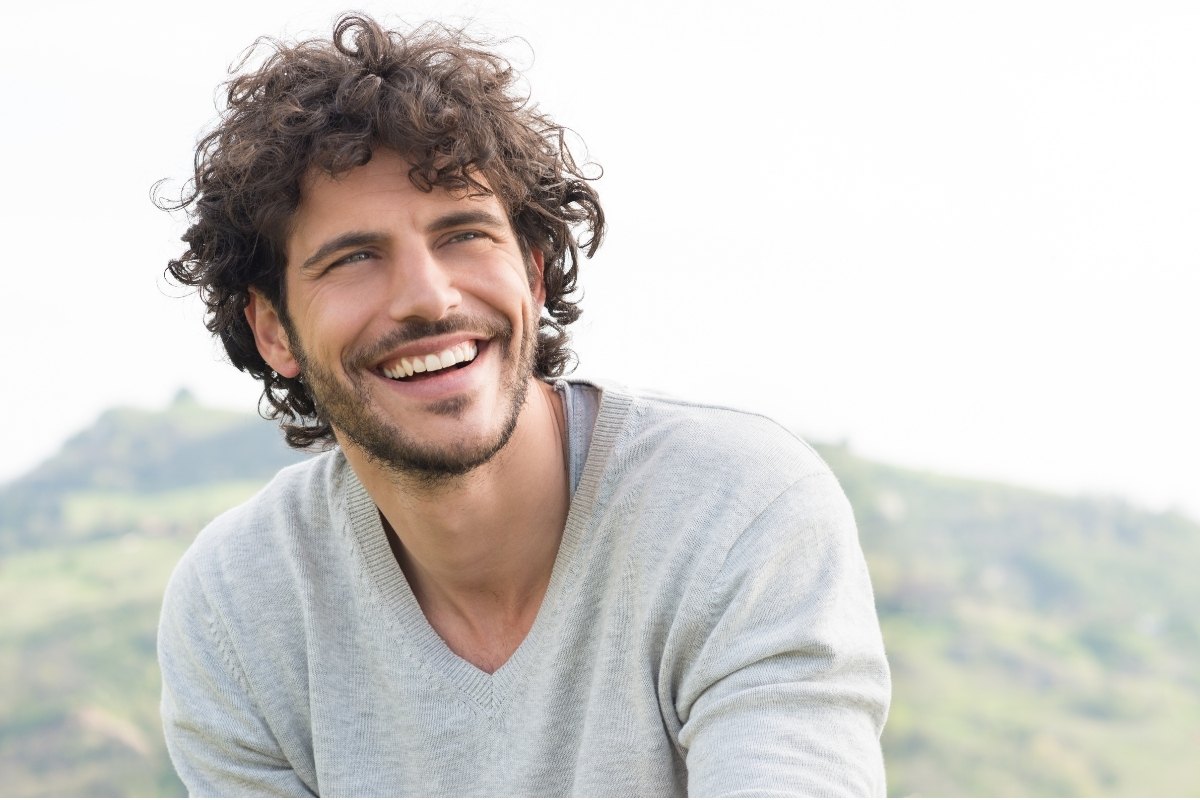 Male staring into the distance and grinning