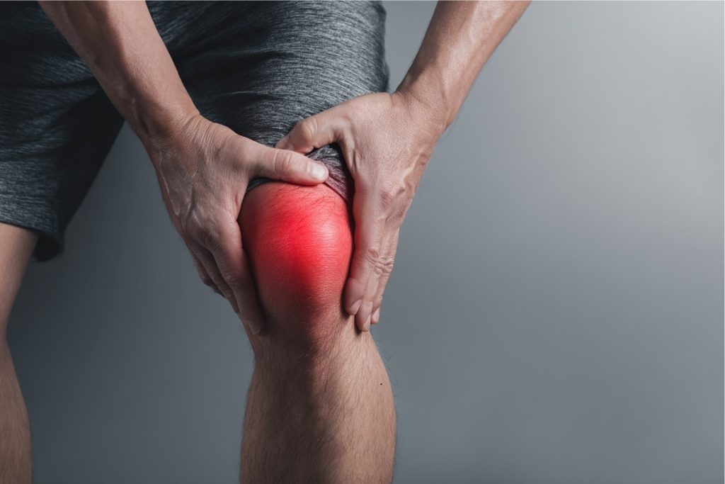 Close up shot of male's knee with red highlighting pain