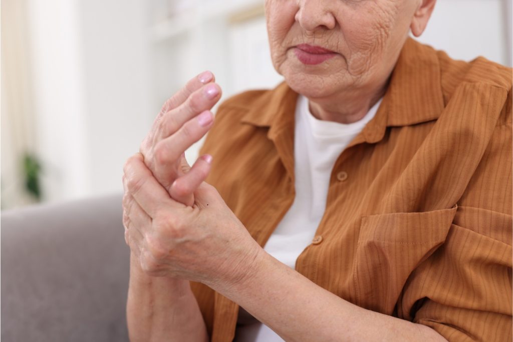 Elderly person with arthritis pain in hand