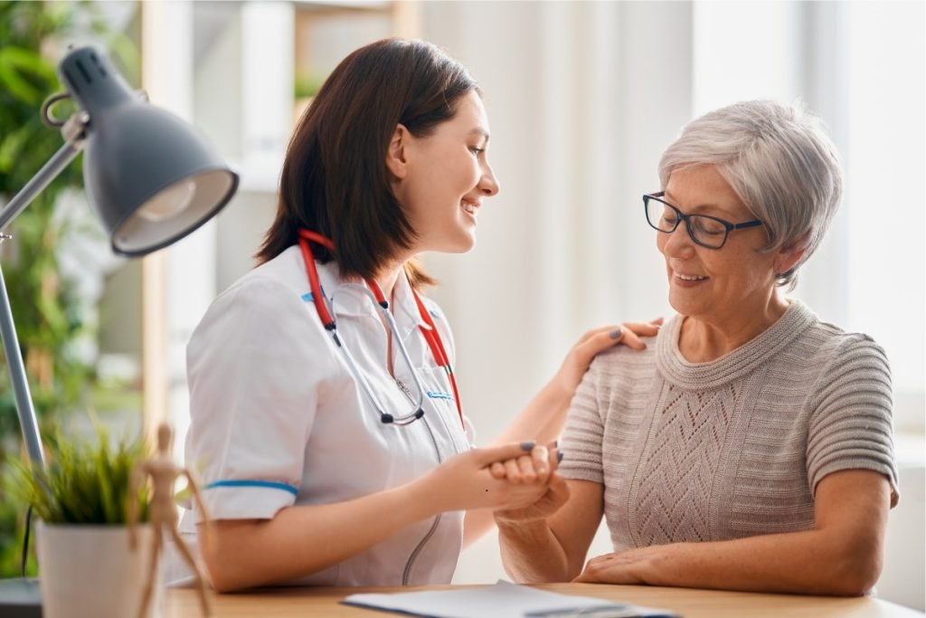 Female doctor smiling and consulting with female patient