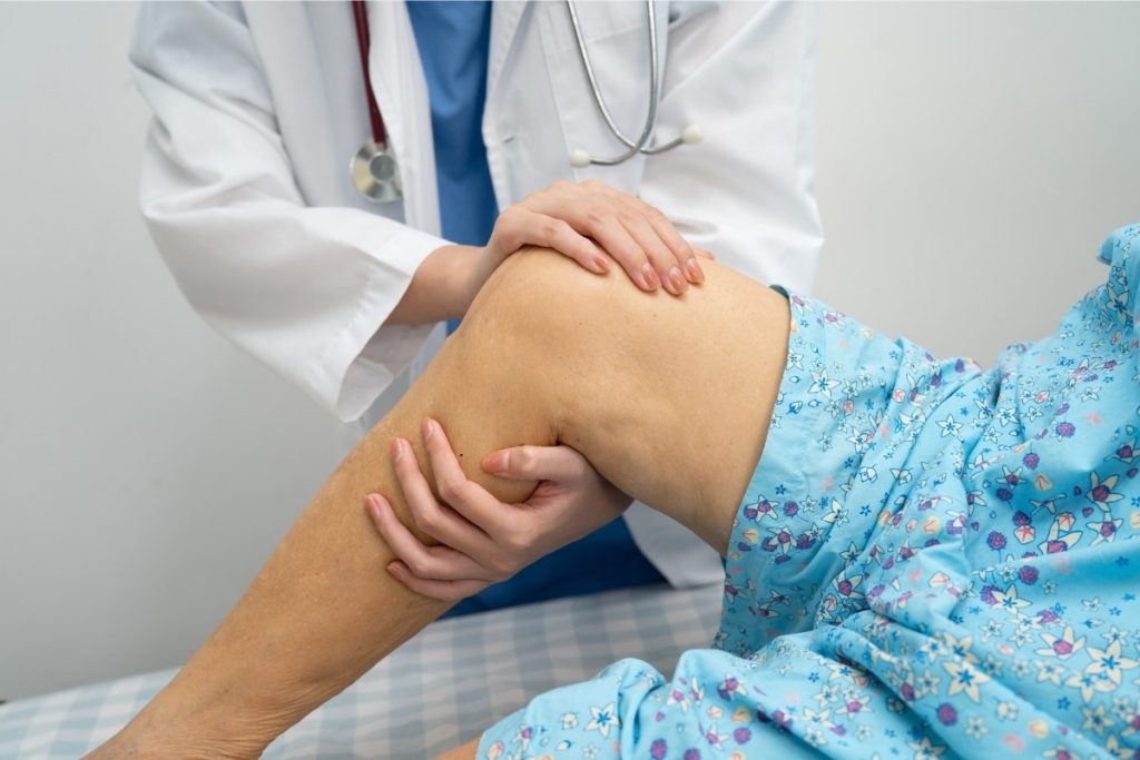 Female doctor treating cartilage injury