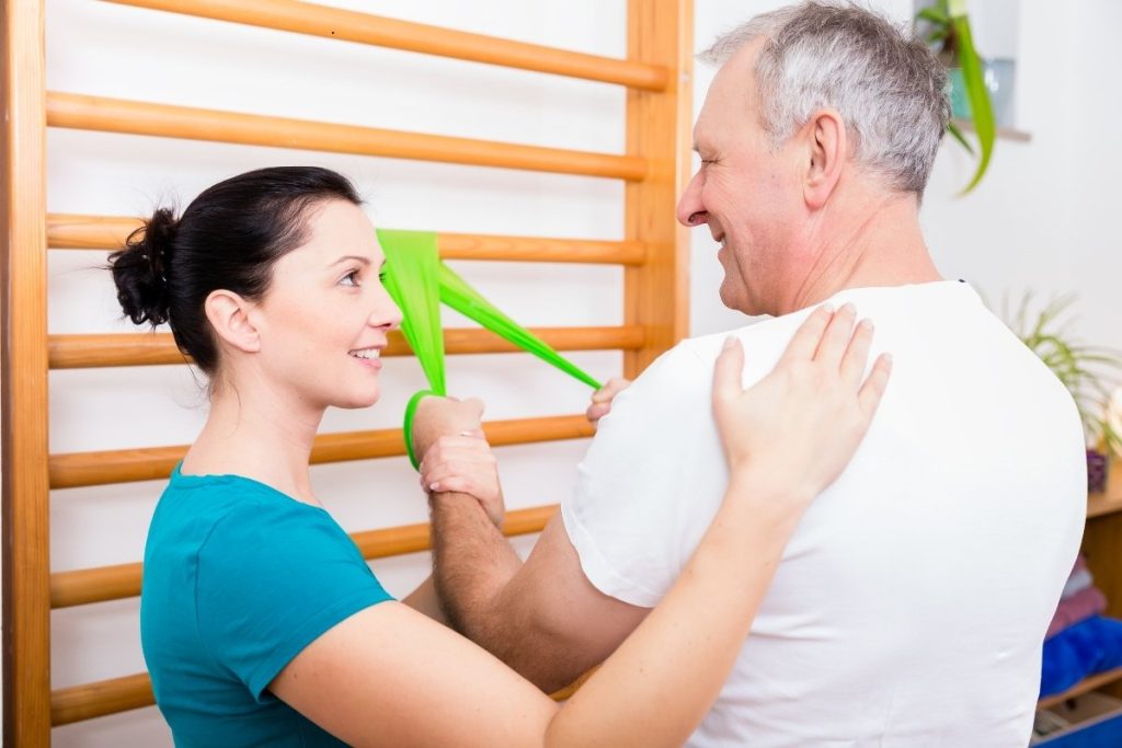 Female physical therapist consulting male patient