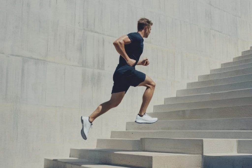Male runner running up stairs