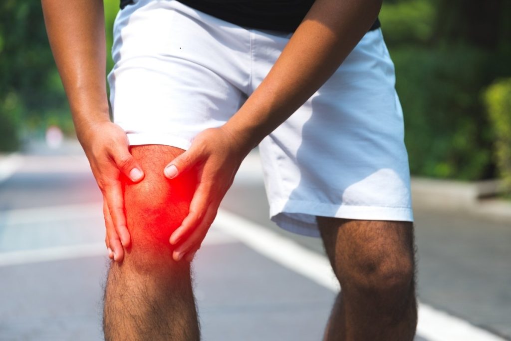Athlete holds swollen knee