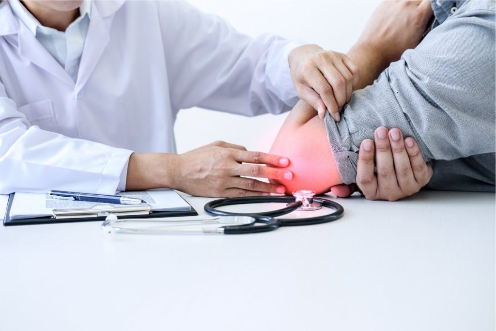 Doctor assesses injured elbow