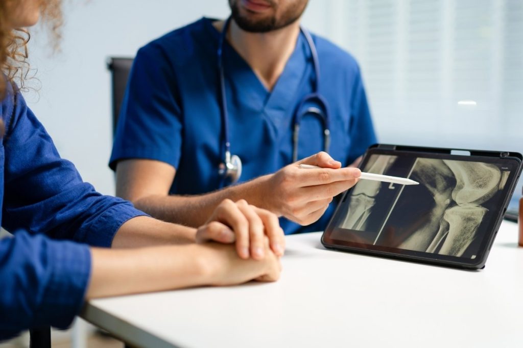 Doctor consults knee patient with their x ray results