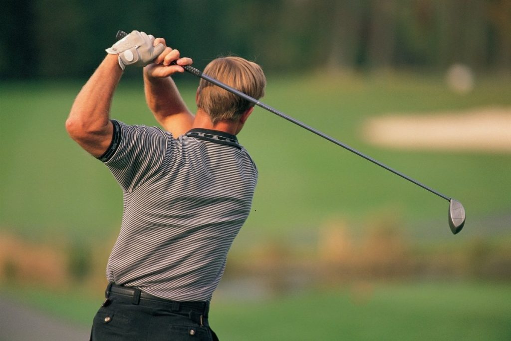 Male golfer taking a swing