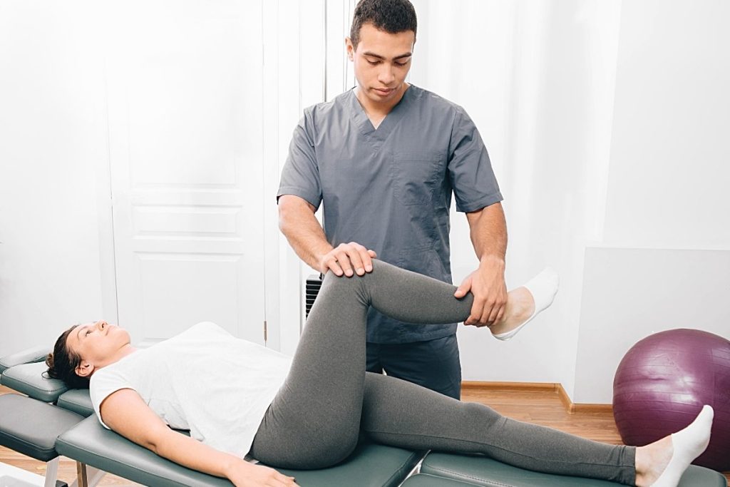 Male physical therapist with female client