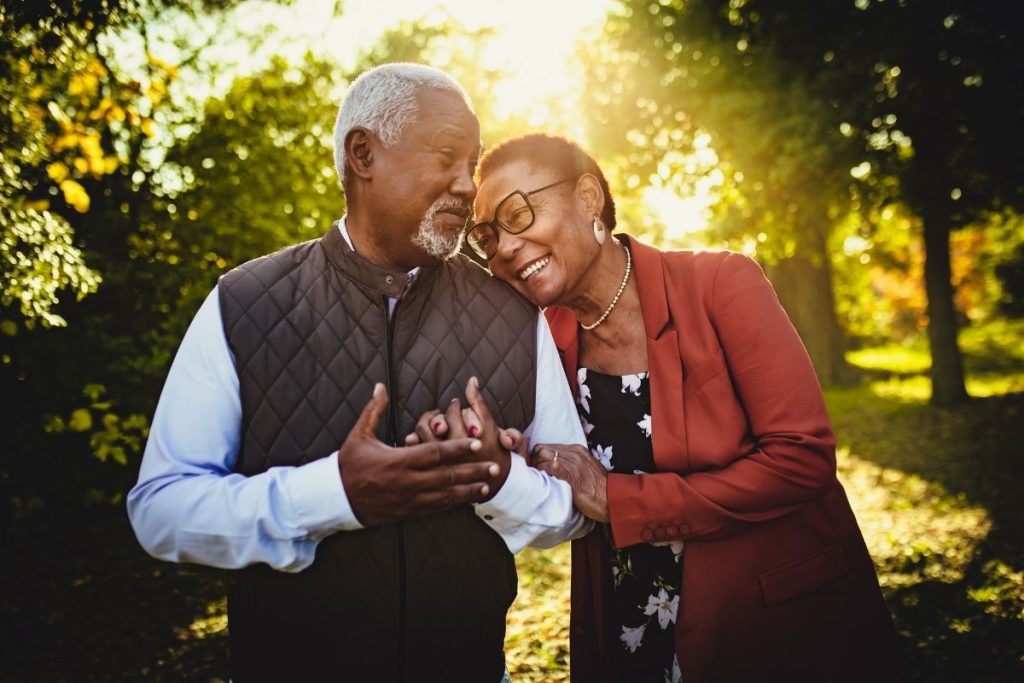 Elderly couple holding hands