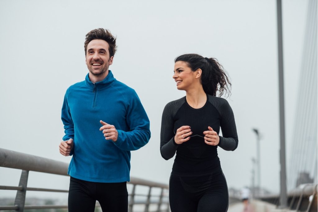 Two adults going for a run